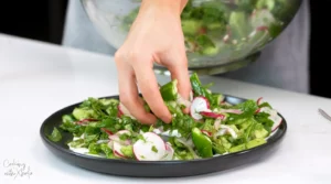 Serving Refreshing Cucumber Yogurt Salad with Sumac & Radishes